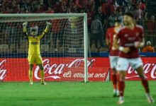 A Football Player In A Yellow Uniform Celebrating A Goal