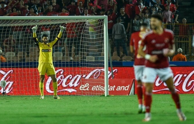 A Football Player In A Yellow Uniform Celebrating A Goal